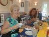 Terry & Patty lift beautiful china cups as they have lunch in the dining room of the Waystead Inn.